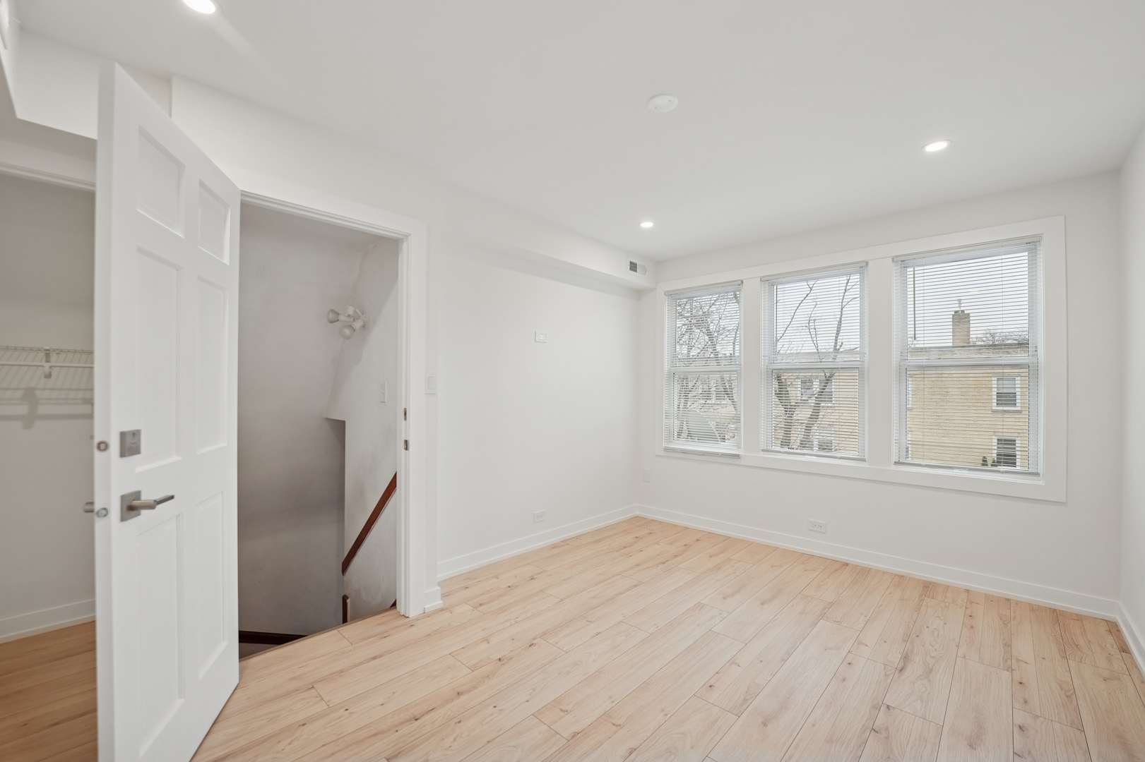 4954 West Byron Street Chicago, IL 60641 - Photo 6 of 33 a view of an empty room with wooden floor and a window