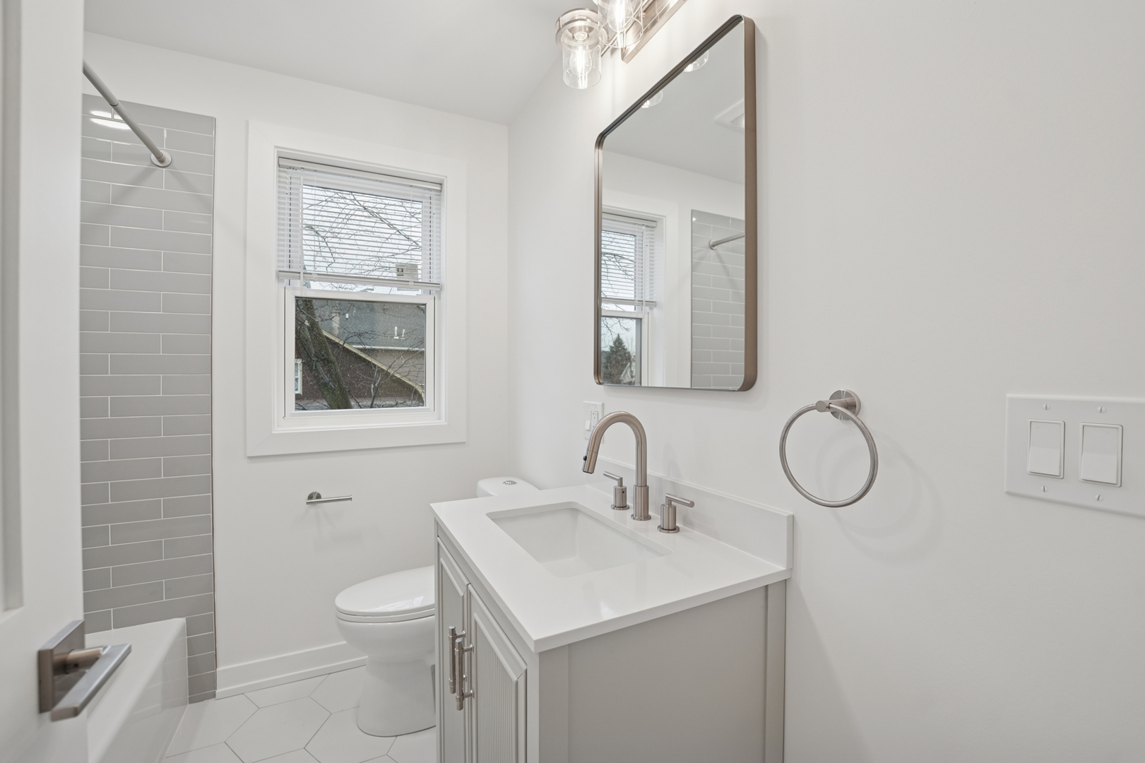 4954 West Byron Street Chicago, IL 60641 - Photo 10 of 33 a bathroom with a toilet sink vanity and mirror