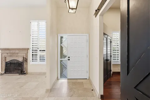 an empty room with wooden floor closet and windows