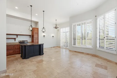 a view of an empty room with a kitchen