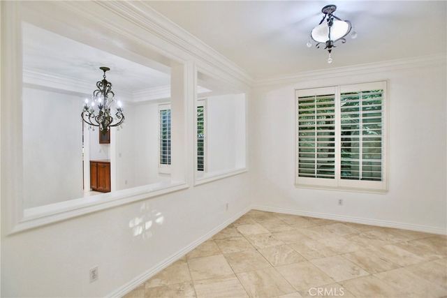 a view of a bedroom with a window and a chandelier
