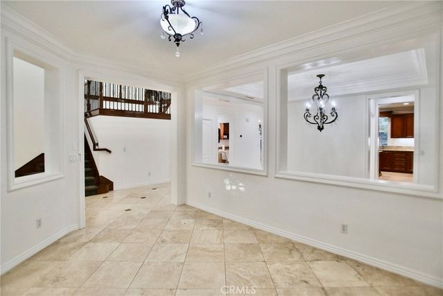 a view of a hallway with a window and chandelier
