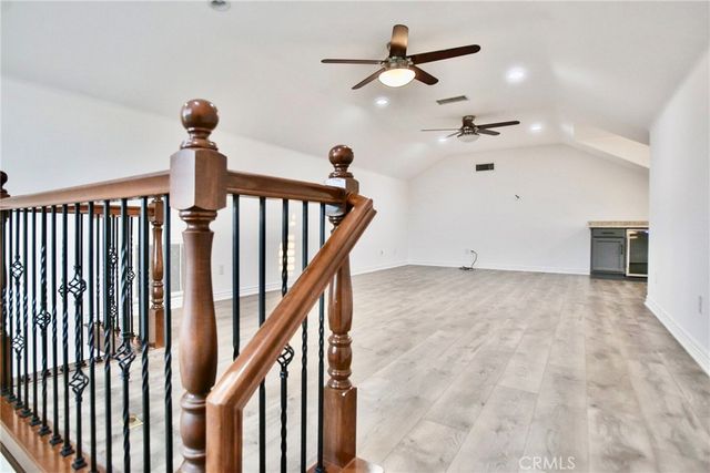 a large kitchen with kitchen island granite countertop wooden cabinets a counter top space and stainless steel appliances