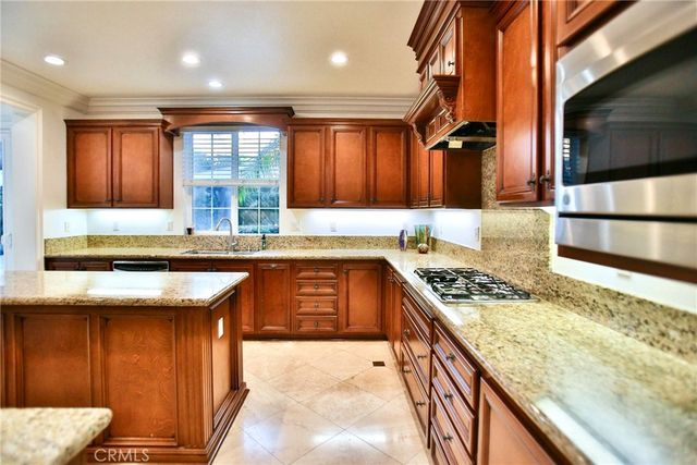 a kitchen with granite countertop cabinets and refrigerator