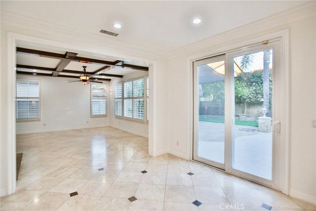 a view of an empty room with a fireplace and a window