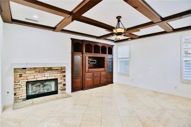 a living room with stainless steel appliances kitchen island granite countertop furniture and a fireplace