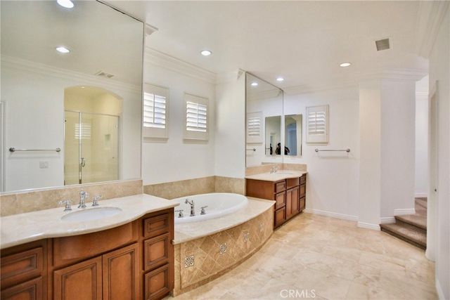a large bathroom with a tub and shower