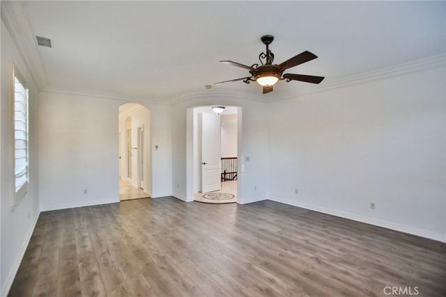 a view of a patio with a table and chairs under an umbrella with a small yard