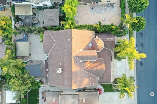 an aerial view of a house with yard and swimming pool