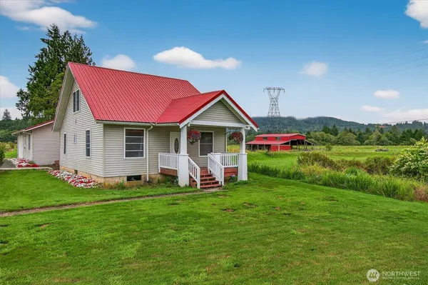 a front view of house with yard and outdoor seating