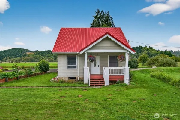 a view of a house with a yard porch and sitting area