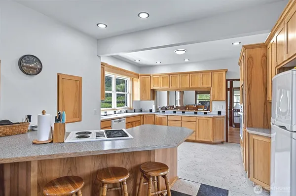 a large kitchen with a table and chairs