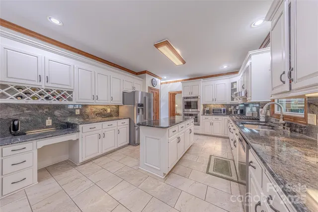 a kitchen with granite countertop cabinets and steel stainless steel appliances