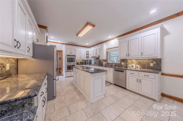 a kitchen with granite countertop cabinets and steel stainless steel appliances