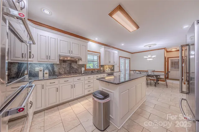 a kitchen with sink cabinets and window
