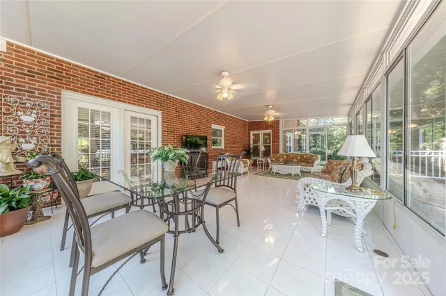 a building outdoor space with patio furniture and potted plants
