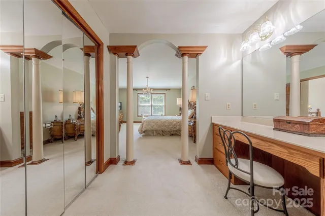 a en suite spacious bathroom with a double vanity sink a mirror and a shower