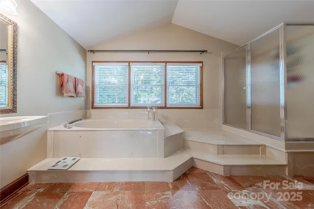 a spacious bathroom with a bathtub and a shower