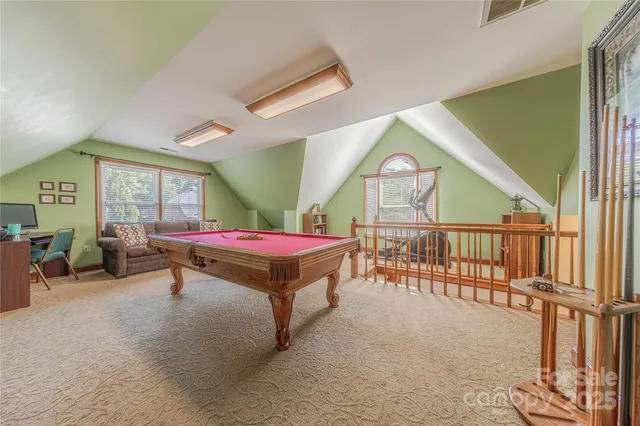 a living room with furniture a rug and a window