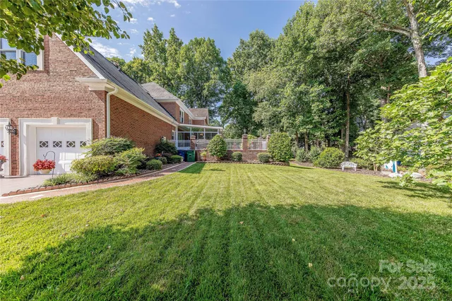 a view of backyard of house with green space