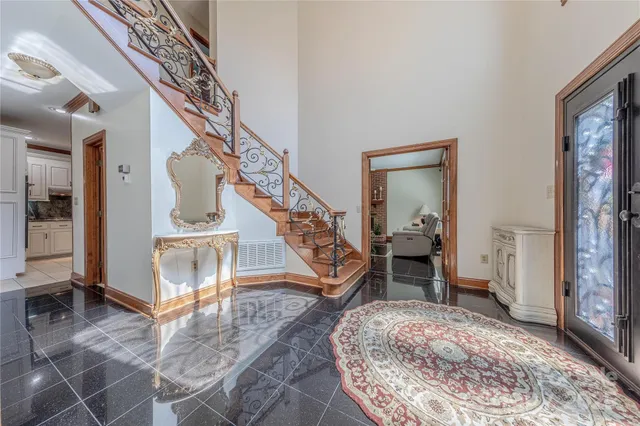 a living room with wooden floor and a rug