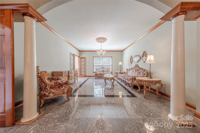 a large room with lots of furniture and a chandelier