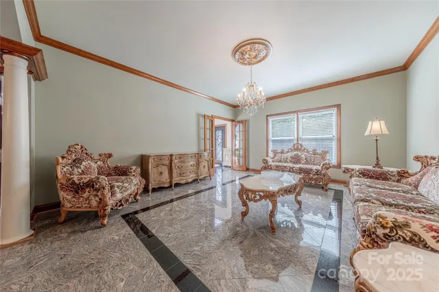 a living room with furniture and a chandelier