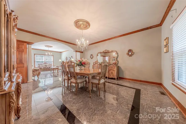 a view of a dining room with furniture and a chandelier