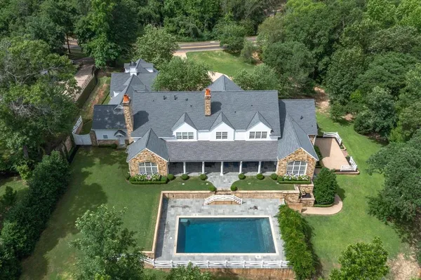 an aerial view of a house with swimming pool patio and outdoor seating