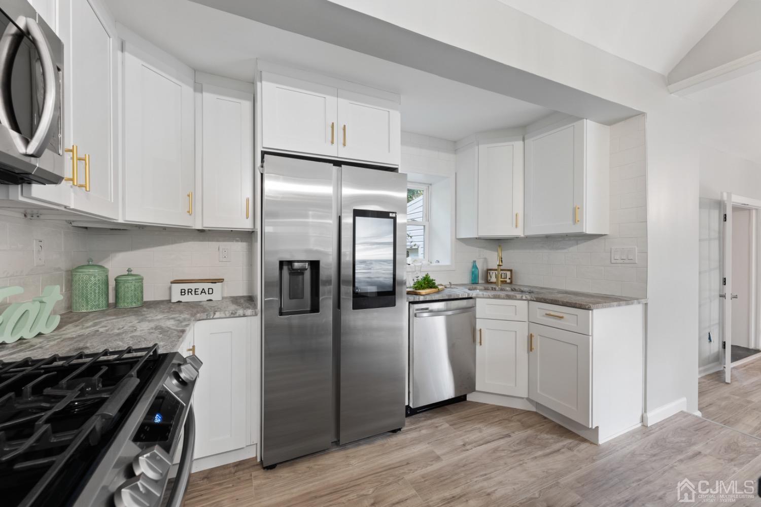 257 Matawan Avenue Matawan, NJ 07747 - Photo 2 of 28 a kitchen with stainless steel appliances granite countertop a stove a refrigerator and a sink