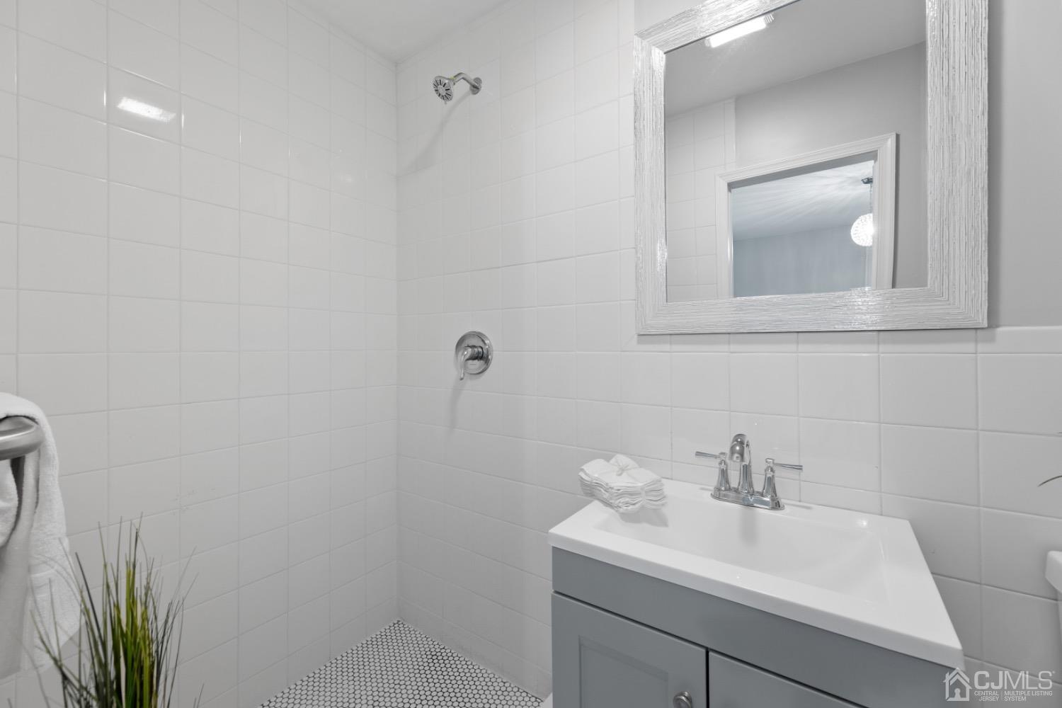 257 Matawan Avenue Matawan, NJ 07747 - Photo 21 of 28 a bathroom with a sink a toilet and mirror