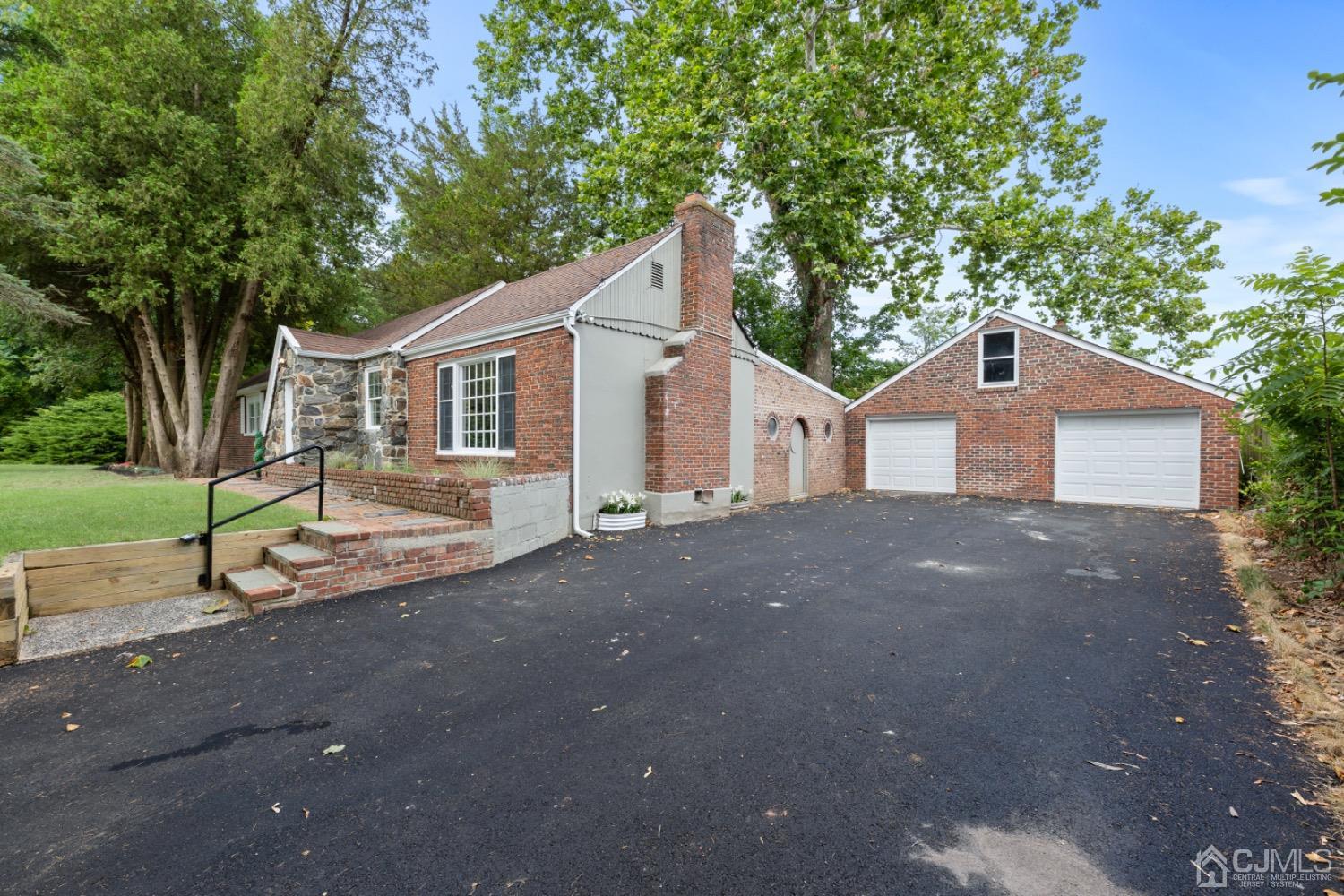 257 Matawan Avenue Matawan, NJ 07747 - Photo 22 of 28 a front view of a house with a yard and garage