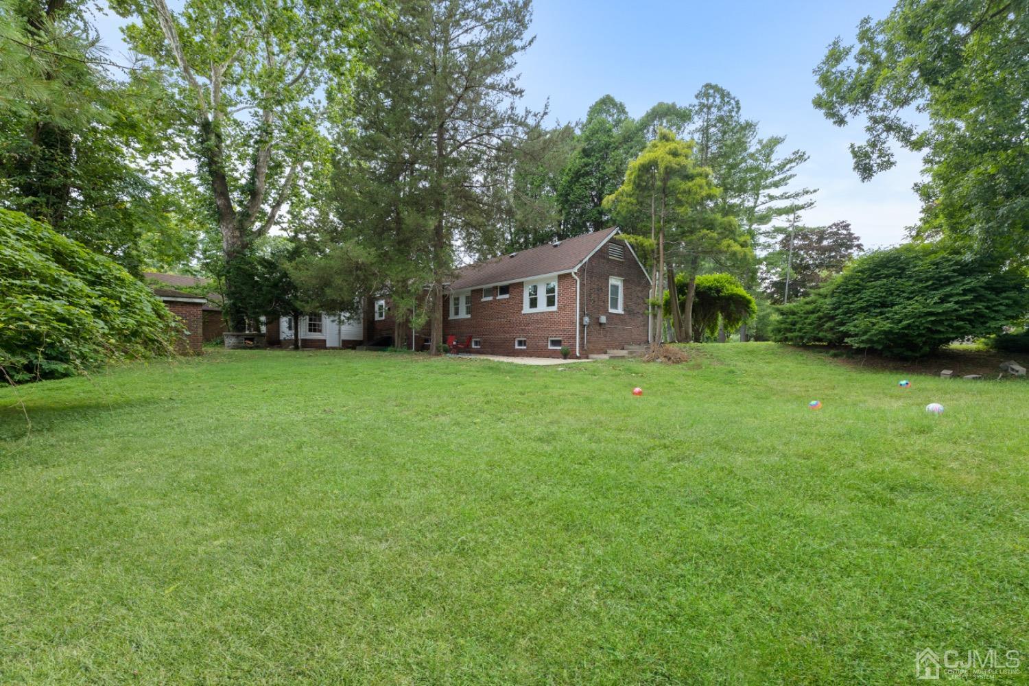 257 Matawan Avenue Matawan, NJ 07747 - Photo 23 of 28 a view of a house with a big yard and large trees