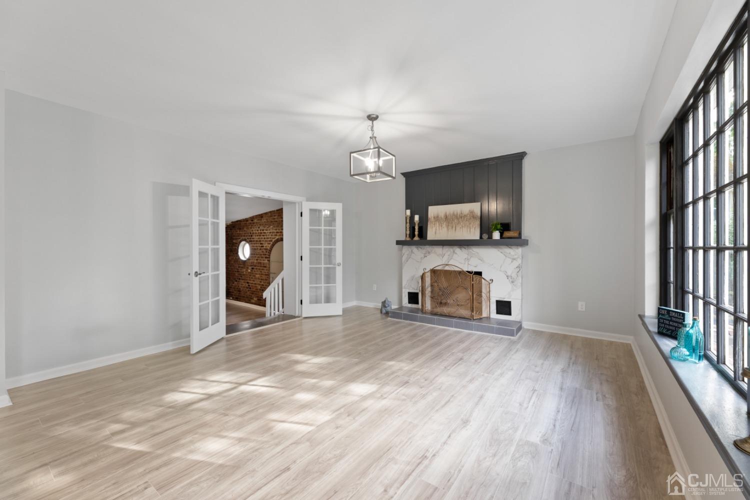 257 Matawan Avenue Matawan, NJ 07747 - Photo 27 of 28 a view of a livingroom with a fireplace a ceiling fan and wooden floor
