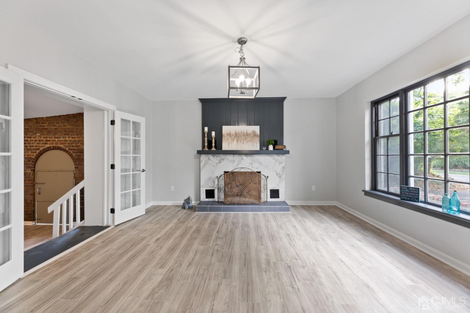 257 Matawan Avenue Matawan, NJ 07747 - Photo 7 of 28 a view of a livingroom with wooden floor and a fireplace