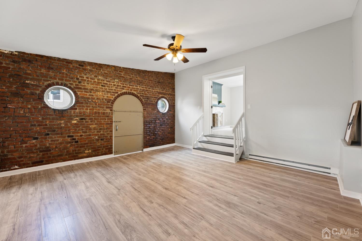257 Matawan Avenue Matawan, NJ 07747 - Photo 9 of 28 a view of a livingroom with wooden floor and a ceiling fan