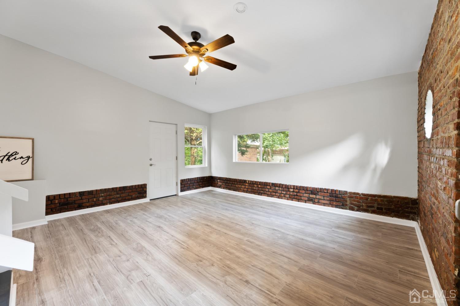 257 Matawan Avenue Matawan, NJ 07747 - Photo 10 of 28 a view of an empty room with wooden floor and a window