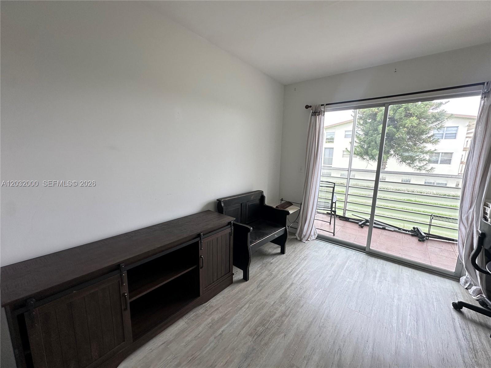 445 Mansfield K, Unit 445 Boca Raton, FL 33434 - Photo 11 of 12 a room with furniture and a wooden floor