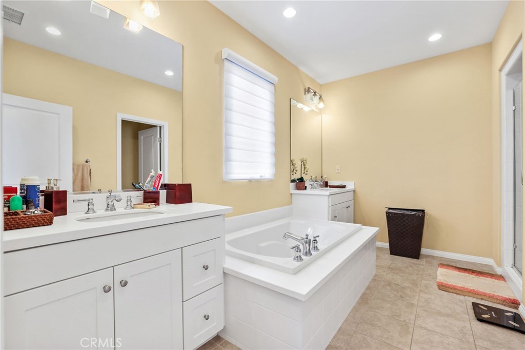 118 Chestnut Grove Irvine, CA 92620 - Photo 12 of 16 a bathroom with a sink a tub and a mirror