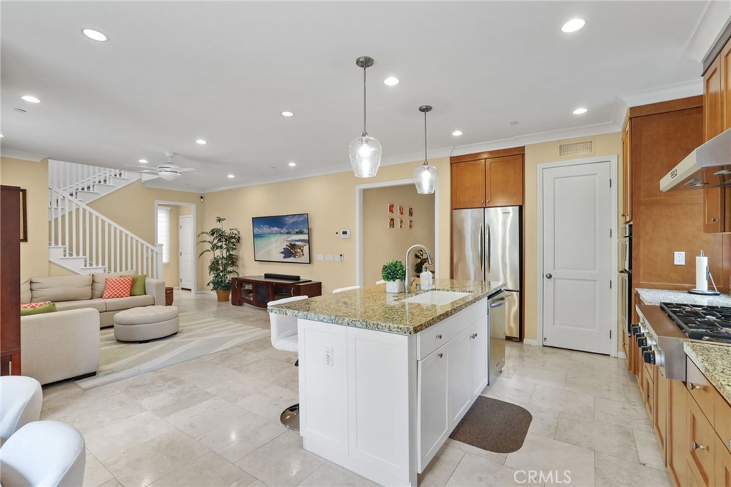 118 Chestnut Grove Irvine, CA 92620 - Photo 2 of 16 a large white kitchen with a large window a sink and stainless steel appliances