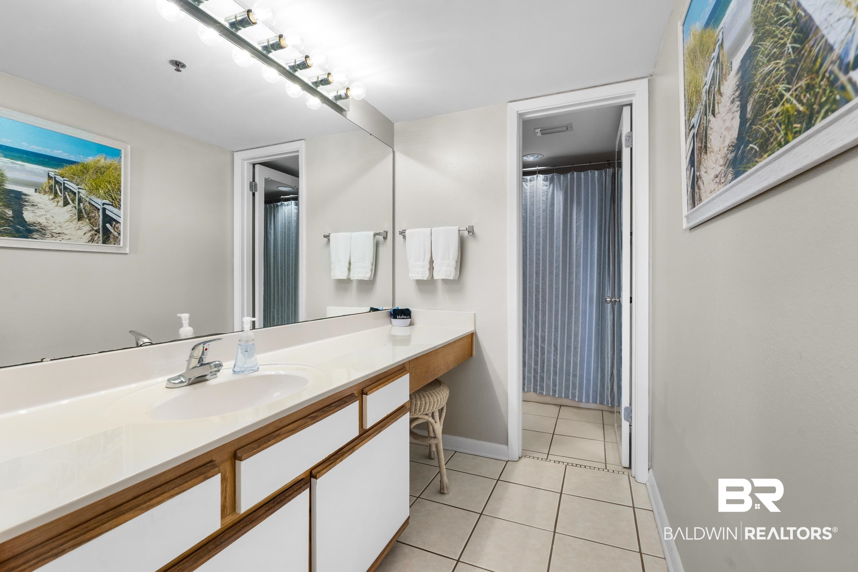 26802 Perdido Beach Boulevard, Unit 406 Orange Beach, AL 36561 - Photo 14 of 37 Full bath with a shower with shower curtain, vanity, and light tile patterned floors