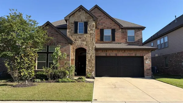 a front view of a house with yard