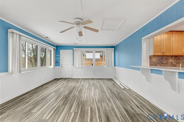 a kitchen with stainless steel appliances granite countertop wooden cabinets a sink and dishwasher a stove with wooden floor