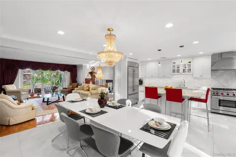 a living room with lots of furniture and a chandelier