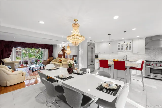 a living room with lots of furniture and a chandelier