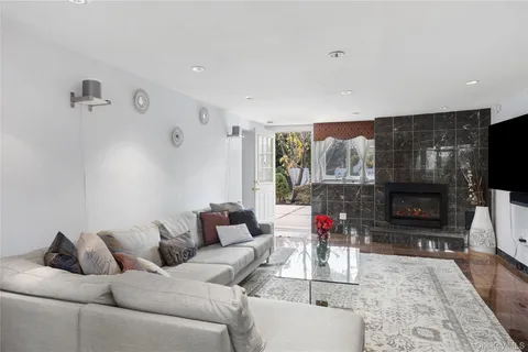 a living room with furniture a flat screen tv and a fireplace