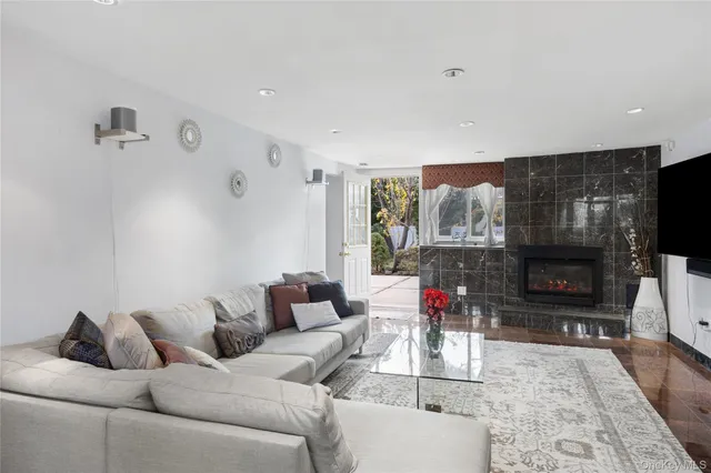 a living room with furniture a flat screen tv and a fireplace