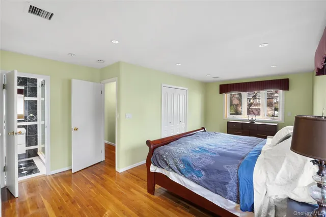 a bedroom with a large bed and a window