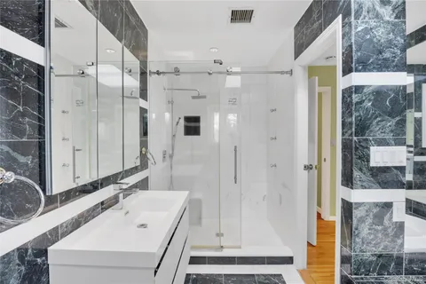 a bathroom with a bathtub and a shower