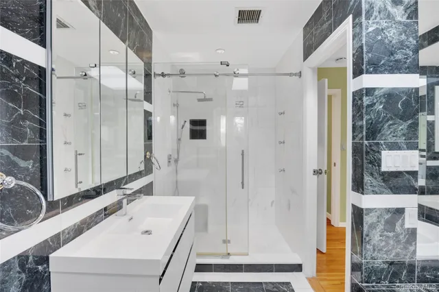 a bathroom with a bathtub and a shower